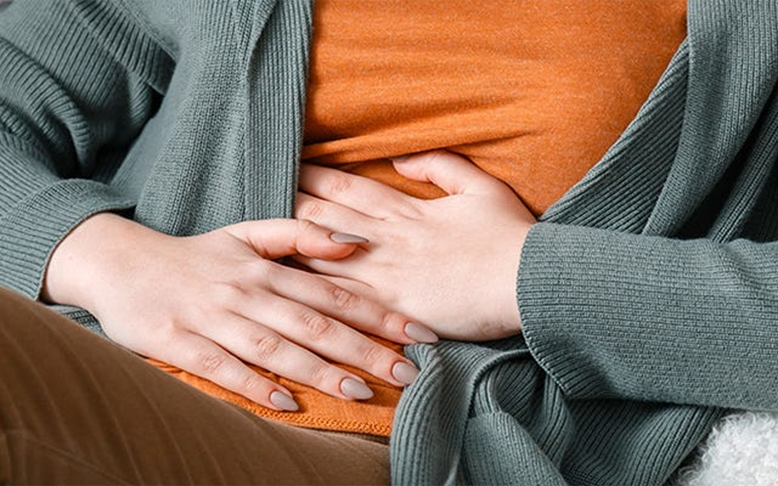 Woman holding upset gut