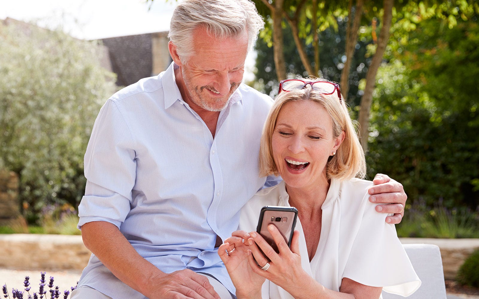 middle aged man and woman on phone