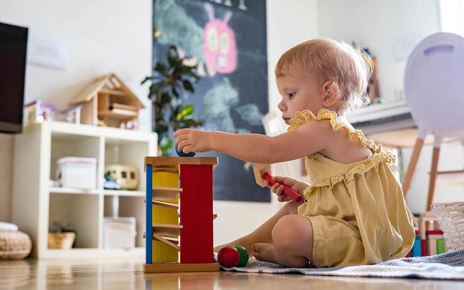 child playing with blocks and balls