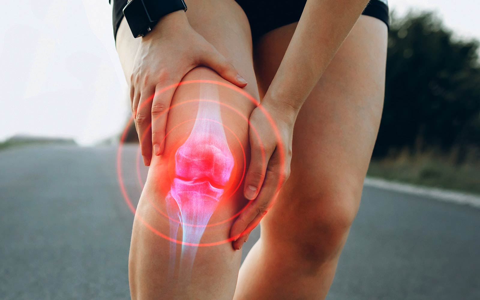 woman holding sore knee