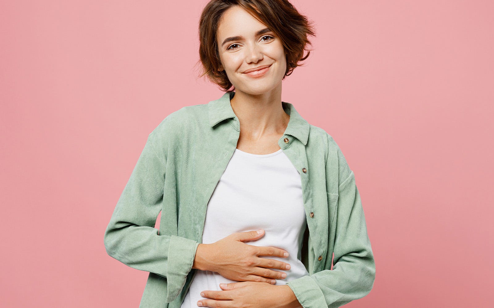 smiling woman holding gut