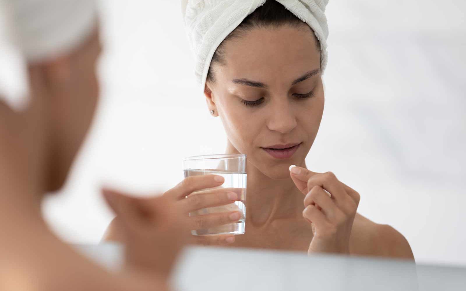 woman taking pill